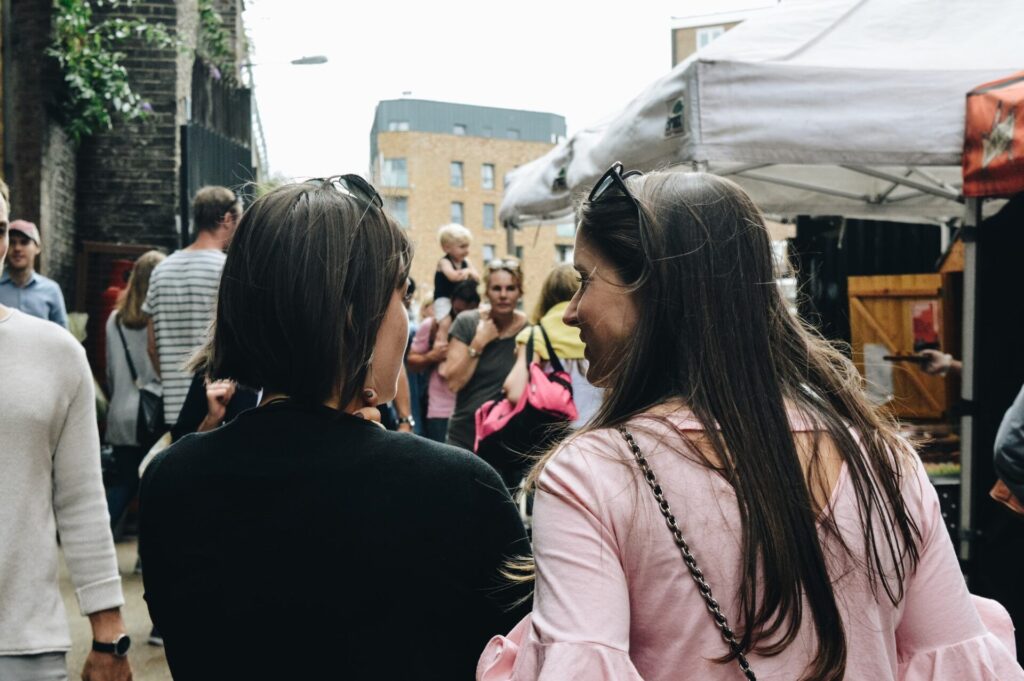 Two women talking in the street. 
