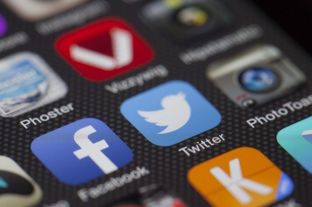 A close-up of social media app icons on a smartphone screen.
